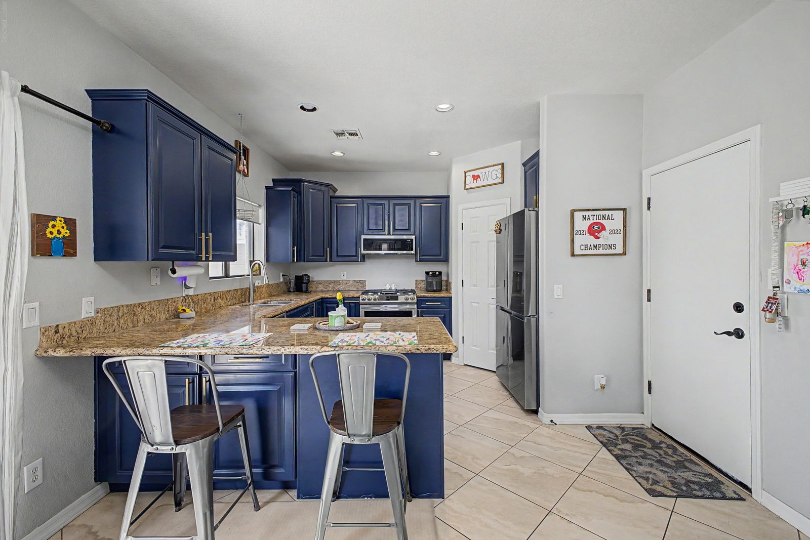 Kitchen with granite breakfast bar and stainless appliances