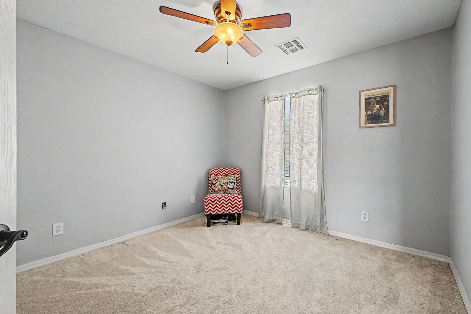 Secondary bedroom with carpet and ceiling fan