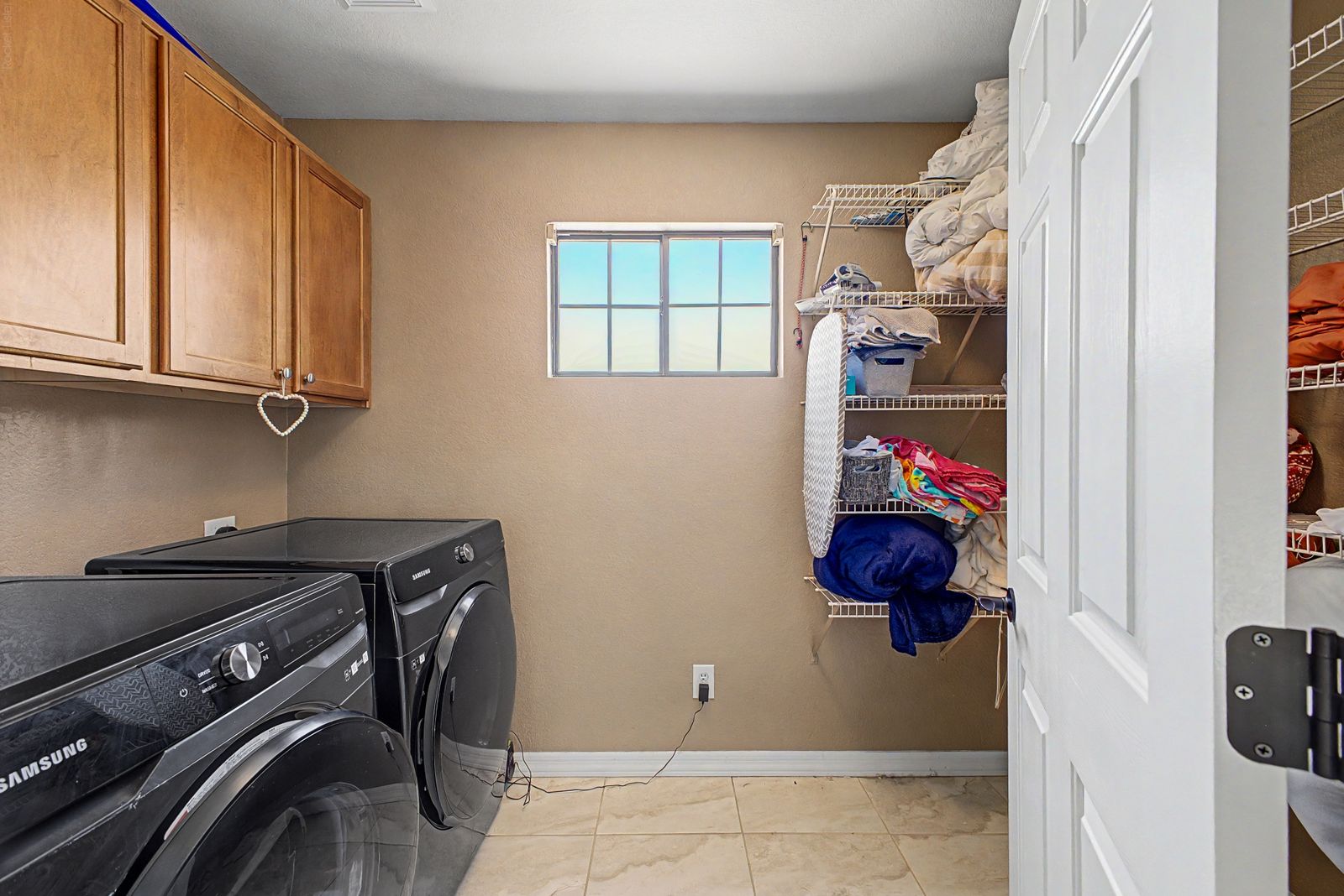 Laundry room with cabinets and shelving