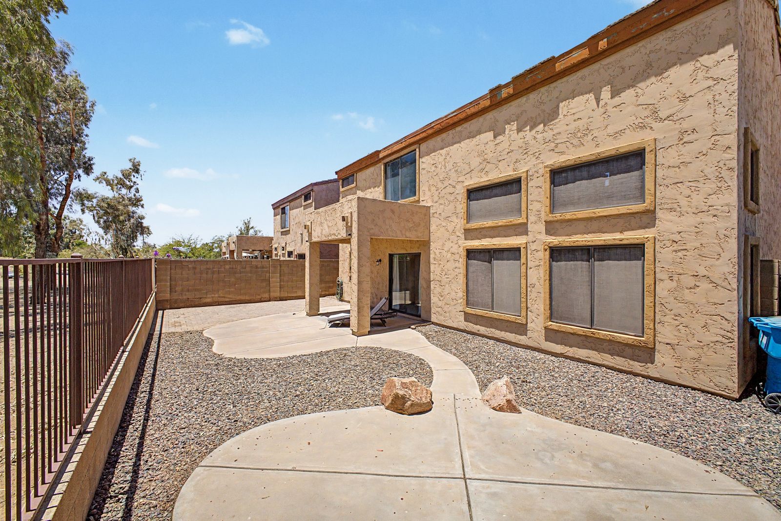 Rear of the home with covered patio and gravel landscaping