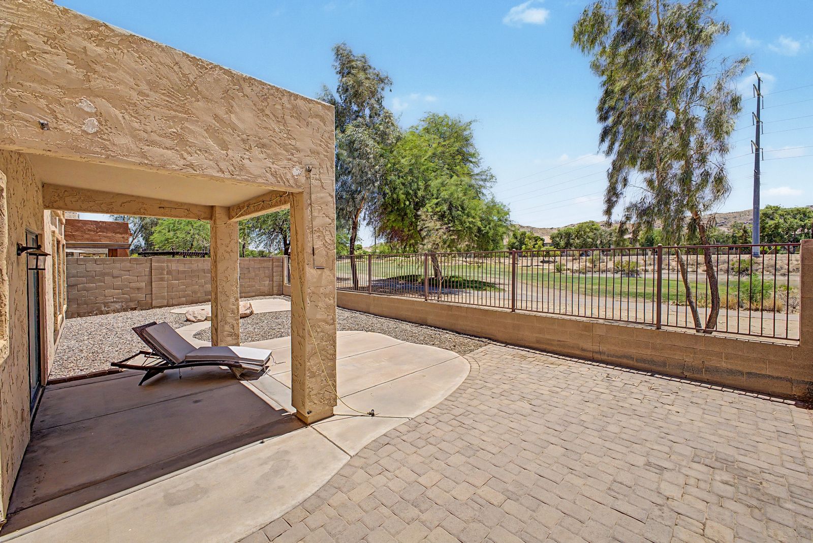 Covered patio with view fencing toward the golf course