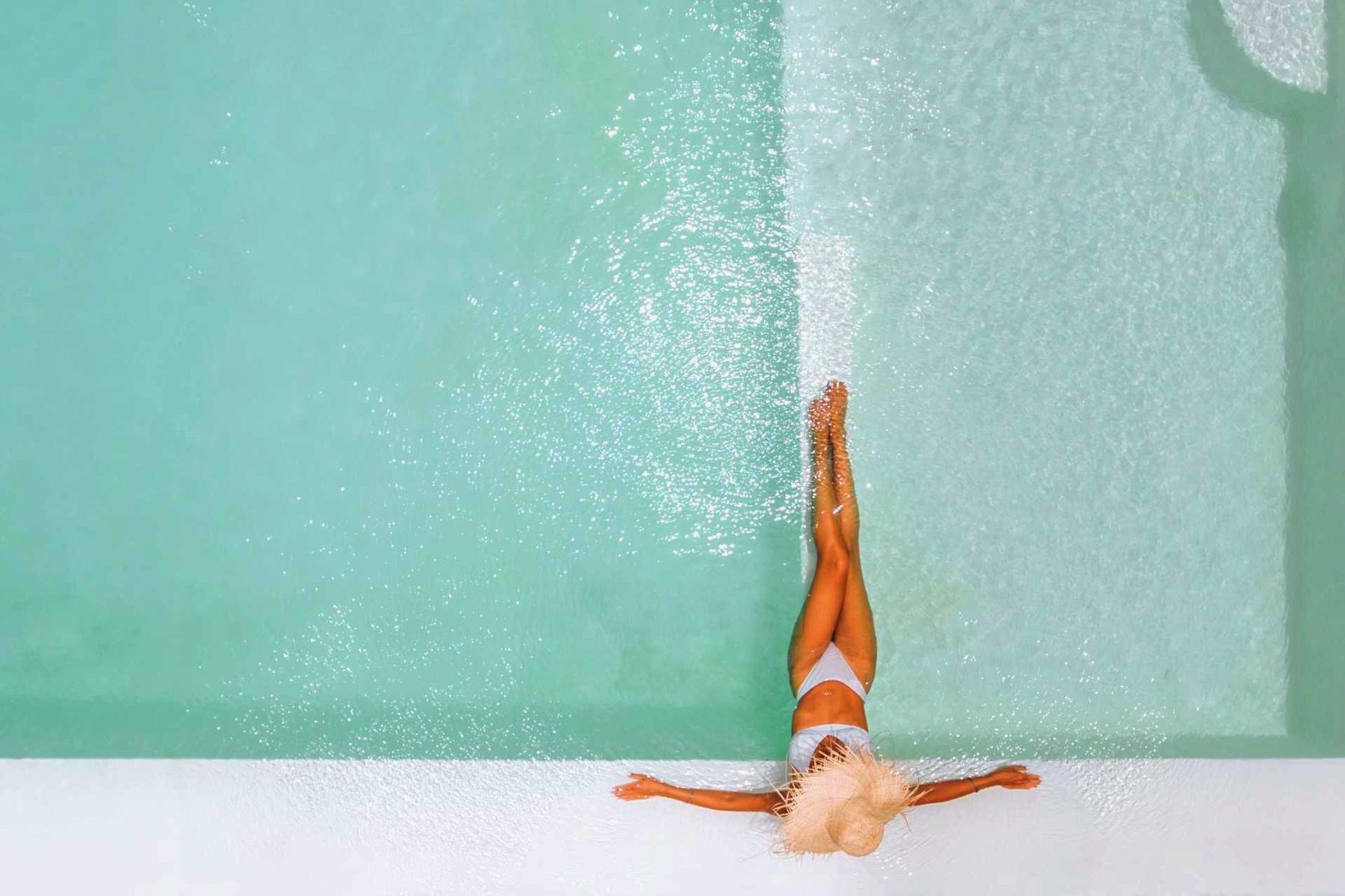 Aerial view of a swimmer floating in a turquoise Arizona pool